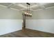 Dining room with wainscoting, coffered ceiling, modern light fixture, and wood floors at 214 Wet Wood Ct # 26, Fairburn, GA 30213