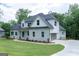 Two-story home with a stone facade, side-entry garage, and lush green lawn at 214 Wet Wood Ct # 26, Fairburn, GA 30213