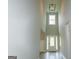 Bright foyer with high ceilings, a modern chandelier and a window over the door at 214 Wet Wood Ct # 26, Fairburn, GA 30213