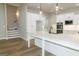 Large kitchen island with pendant lights, white countertops, and stainless steel appliances at 214 Wet Wood Ct # 26, Fairburn, GA 30213