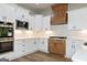 Kitchen showcasing stainless steel appliances, white countertops, and custom range hood at 214 Wet Wood Ct # 26, Fairburn, GA 30213