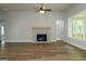 Spacious living room with stone fireplace, ceiling fan, and large windows at 214 Wet Wood Ct # 26, Fairburn, GA 30213