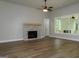 Living room featuring wood floors, stone fireplace and access to a back porch at 214 Wet Wood Ct # 26, Fairburn, GA 30213