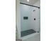 Modern walk-in shower featuring white subway tile, built-in niche and dark mosaic tile flooring at 214 Wet Wood Ct # 26, Fairburn, GA 30213