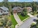 Aerial view of homes with lush lawns, mature trees and long driveways at 2390 Colchester Ct, Cumming, GA 30041