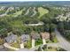 Aerial view of several upscale homes nestled among lush trees and green golf course at 2390 Colchester Ct, Cumming, GA 30041