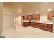 Basement kitchenette with wood cabinets, granite countertops, and tile flooring for convenient entertaining at 2390 Colchester Ct, Cumming, GA 30041