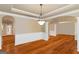 Traditional dining room showcases beautiful wainscoting, trimwork, and arched entryways at 2390 Colchester Ct, Cumming, GA 30041