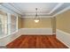 Classic dining room features tray ceilings, wainscoting and an elegant chandelier at 2390 Colchester Ct, Cumming, GA 30041