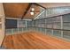 Sunroom showcasing hardwood floors, paneled walls, and multiple windows that offer scenic outdoor views at 2390 Colchester Ct, Cumming, GA 30041