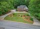 Aerial view of a brick home with a circular driveway and lush, landscaped front yard at 30 Joe Lee Dr, Sharpsburg, GA 30277
