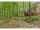 Beautiful backyard featuring a stone path leading to the home with a deck and lush greenery at 30 Joe Lee Dr, Sharpsburg, GA 30277