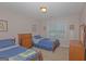Bedroom with carpet, two twin beds, two dressers, and a window at 30 Joe Lee Dr, Sharpsburg, GA 30277
