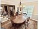 A traditional dining room with wood floors, a chandelier, and a window providing natural light at 30 Joe Lee Dr, Sharpsburg, GA 30277