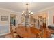 Open dining area includes staircase, glass display cabinet, and views into other living spaces at 30 Joe Lee Dr, Sharpsburg, GA 30277