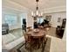 Open-concept dining area with decorative chandelier and views into the spacious living room at 30 Joe Lee Dr, Sharpsburg, GA 30277
