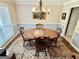 Sunlit dining room featuring an elegant chandelier, round table, and traditional rug at 30 Joe Lee Dr, Sharpsburg, GA 30277