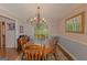 Traditional dining room features hardwood floors, wainscoting, decorative mirror, and elegant chandelier at 30 Joe Lee Dr, Sharpsburg, GA 30277