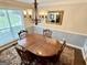 Traditional dining room featuring a wooden table, chairs, chandelier, and large window with natural light at 30 Joe Lee Dr, Sharpsburg, GA 30277