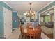 Charming dining room with wooden table, stylish chandelier, and easy kitchen access at 30 Joe Lee Dr, Sharpsburg, GA 30277