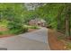 Charming brick home with manicured landscaping, a circular driveway, and mature trees at 30 Joe Lee Dr, Sharpsburg, GA 30277