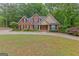 Gorgeous brick home with manicured lawn and a charming, traditional facade at 30 Joe Lee Dr, Sharpsburg, GA 30277