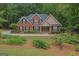 Charming brick home with black shutters, lush landscaping, and a welcoming front entrance at 30 Joe Lee Dr, Sharpsburg, GA 30277