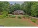 Beautiful brick home surrounded by mature trees and a well-manicured lawn at 30 Joe Lee Dr, Sharpsburg, GA 30277
