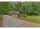 Beautiful brick home showcasing a well-manicured front yard, driveway, and lush greenery at 30 Joe Lee Dr, Sharpsburg, GA 30277