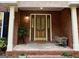 Charming brick entryway with decorative glass front door, large planters, and a 'Welcome' mat at 30 Joe Lee Dr, Sharpsburg, GA 30277