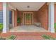 Welcoming covered front porch with brick accents and decorative details at 30 Joe Lee Dr, Sharpsburg, GA 30277