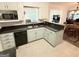Functional kitchen features granite countertops, tiled flooring, and stainless steel sink at 30 Joe Lee Dr, Sharpsburg, GA 30277