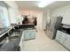 Well-lit kitchen offers stainless steel refrigerator and a seamless view into the dining room at 30 Joe Lee Dr, Sharpsburg, GA 30277
