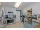 Well-lit kitchen with stainless steel appliances, granite countertops, and decorative backsplash at 30 Joe Lee Dr, Sharpsburg, GA 30277