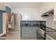 Kitchen with stainless steel refrigerator, granite countertops, and overhead cabinets at 30 Joe Lee Dr, Sharpsburg, GA 30277