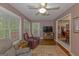Comfortable living room featuring wood floors, a TV, and a door to the outside at 30 Joe Lee Dr, Sharpsburg, GA 30277