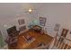 Open-concept living area with wood floors, a brick fireplace, and large windows for natural light at 30 Joe Lee Dr, Sharpsburg, GA 30277