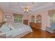 Bedroom features a ceiling fan, wood floors, and multiple dressers, offering ample storage at 30 Joe Lee Dr, Sharpsburg, GA 30277