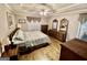 Cozy main bedroom with hardwood floors, a tray ceiling, and ample closet space for optimal storage at 30 Joe Lee Dr, Sharpsburg, GA 30277