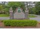 Stone Canongate Village entrance sign with manicured shrubbery at 30 Joe Lee Dr, Sharpsburg, GA 30277