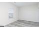 Minimalist bedroom design with light gray flooring, a window with white blinds, and neutral walls at 3402 Arabian Farm Ln, Dacula, GA 30019