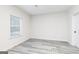 Minimalist bedroom design with light gray flooring, a window with white blinds, and neutral walls at 3402 Arabian Farm Ln, Dacula, GA 30019