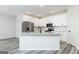 Modern kitchen featuring white cabinetry, stainless steel appliances, granite countertops, and a kitchen island at 3402 Arabian Farm Ln, Dacula, GA 30019