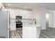 Well-lit kitchen featuring white cabinets, stainless steel appliances, granite counters, and hardwood floors at 3402 Arabian Farm Ln, Dacula, GA 30019