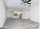 Open-concept living room flows into kitchen with white cabinets, stainless steel appliances, and an island at 3402 Arabian Farm Ln, Dacula, GA 30019