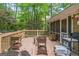 Wooden deck with seating and railings overlooks the wooded backyard area at 2201 Valley Creek Cir, Snellville, GA 30078