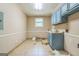 Unfinished basement area features blue cabinets, window, and concrete flooring at 2201 Valley Creek Cir, Snellville, GA 30078