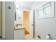 Bathroom with a granite countertop, a small window with blinds and gray painted walls at 2201 Valley Creek Cir, Snellville, GA 30078