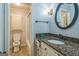Bright bathroom featuring granite countertop, decorative mirror, and walk in shower at 2201 Valley Creek Cir, Snellville, GA 30078