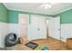 View of a bedroom with hardwood flooring, connecting doors, and wainscoting at 2201 Valley Creek Cir, Snellville, GA 30078